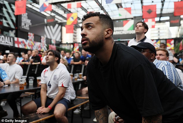 A man watches England struggle on into stoppage time at BoxPark in Croydon