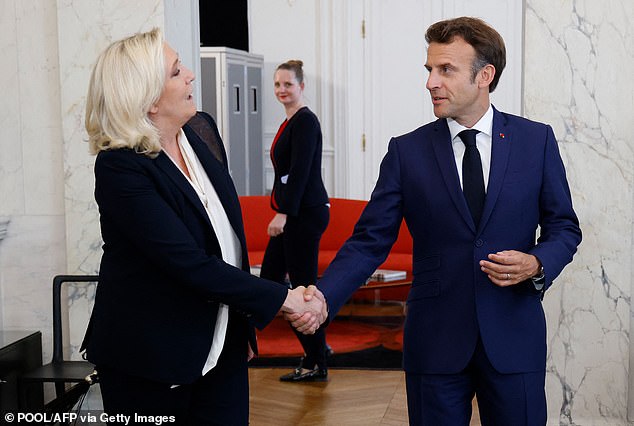 Le Pen shakes hands with President Emmanuel Macron after talks at the presidential Elysee Palace, in Paris, on June 21, 2022