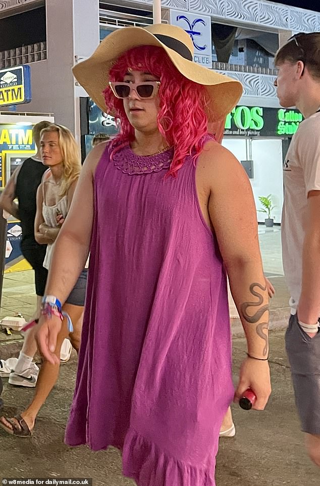 One youngster was seen wearing a purple dress, sunhat and bright pink wig as he strutted down the strip with pals