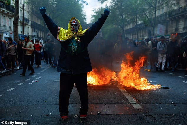 People demonstrate on the streets as May Day protests coincide with weeks of public outrage over a pension-reform law that increased the country's retirement age from 62 to 64, on May 1, 2023 in Paris, France