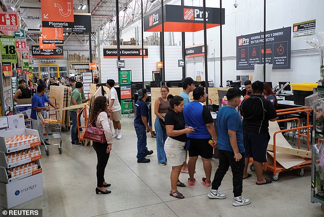People are seen shopping for wood in Cancun, Mexico on June 30, 2024 in a bid to protect their windows as they prepare for the arrival of Hurricane Beryl
