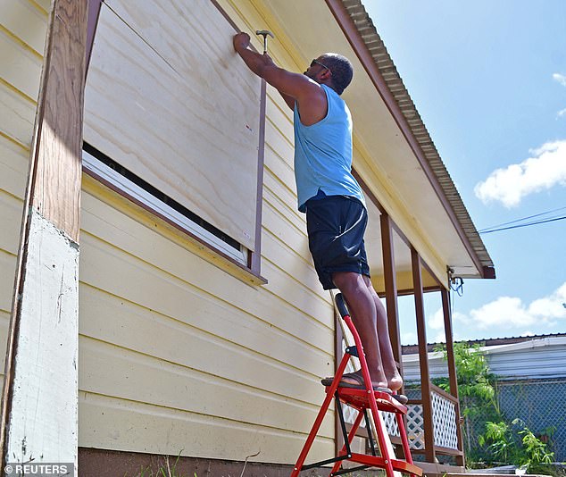 A man boards up a house ahead of the arrival of Hurricane Beryl in Bridgetown, Barbados June 30, 2024