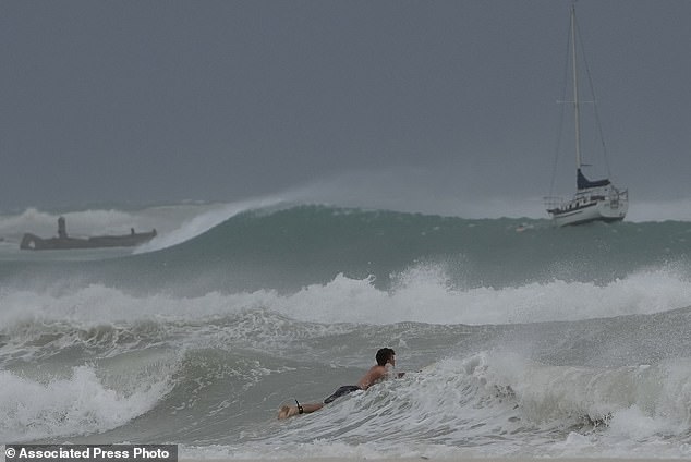 A surfer braves the waves in Carlisle Bay as Hurricane Beryl passes through Bridgetown, Barbados, July 1, 2024