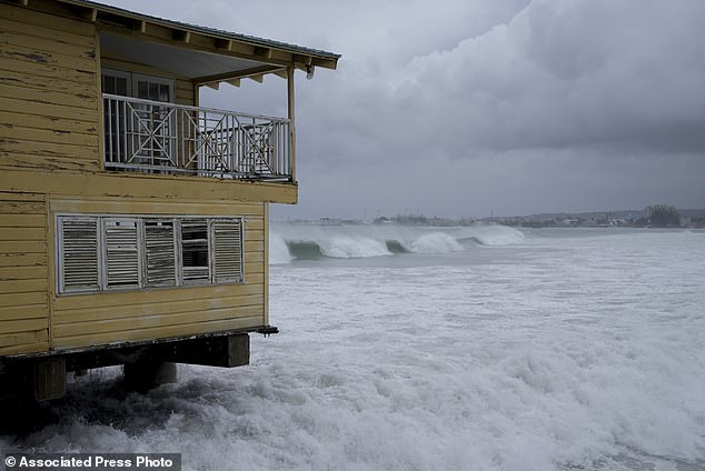 Waves batter a pier during the pass of Hurricane Beryl in Bridgetown, Barbados on July 1, 2024