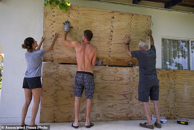 Residents cover the windows of their home in preparation for the arrival of Hurricane Beryl in Bridgetown, Barbados on June 30, 2024