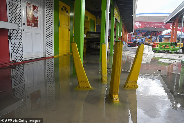 Damaged outdoor furniture is seen in a flooded area after the passage of Hurricane Beryl in Oistins gardens, Christ Church, Barbados on July 1, 2024