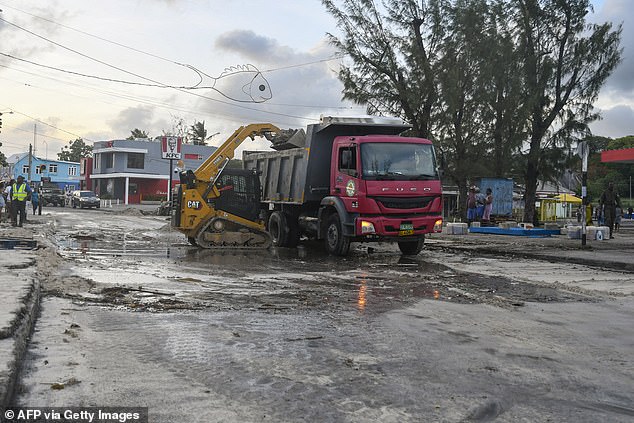 Staff from the Ministry of Transport, Works and Infrastructure clear debris on the main road after the passage of Hurricane Beryl in Oistins, Christ Church, Barbados on July 1, 2024