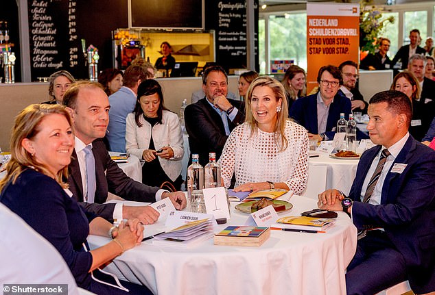 She quickly got down to business and was pictured deep in conversation with other attendees, making notes through the course of the meeting