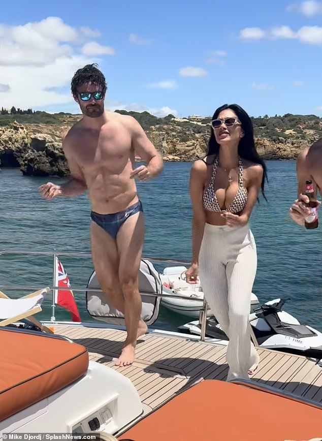 Nicole Scherzinger and her fiancé Thom Evans looked on cloud nine as they partied on a yacht while on holiday in the Algarve