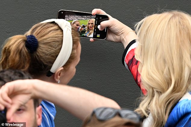 Rebel did the honours as another fan asked for a selfie at Wimbledon on Tuesday afternoon