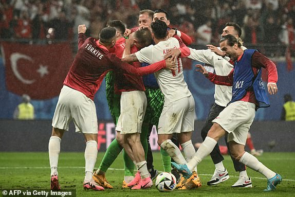 Turkey's forward #17 Irfan Kahveci (C) and teammates celebrate at the end of the UEFA Euro 2024 round of 16 football match between Austria and Turkey at the Leipzig Stadium in Leipzig on July 2, 2024. (Photo by Angelos Tzortzinis / AFP) (Photo by ANGELOS TZORTZINIS/AFP via Getty Images)