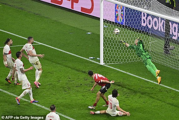 Turkey's goalkeeper #01 Mert Gunok saves the ball during the UEFA Euro 2024 round of 16 football match between Austria and Turkey at the Leipzig Stadium in Leipzig on July 2, 2024. (Photo by JOHN MACDOUGALL / AFP) (Photo by JOHN MACDOUGALL/AFP via Getty Images)