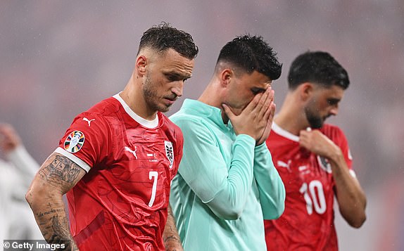 LEIPZIG, GERMANY - JULY 02: Marko Arnautovic of Austria looks dejected as he reacts with teammates after defeat to Turkiye during the UEFA EURO 2024 round of 16 match between Austria and Turkiye at Football Stadium Leipzig on July 02, 2024 in Leipzig, Germany. (Photo by Stu Forster/Getty Images)