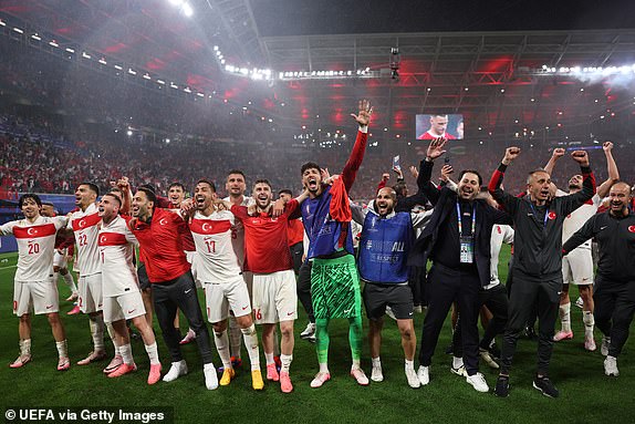 LEIPZIG, GERMANY - JULY 02: Players and Coaching Staff of Turkiye celebrate in front of the fans after the team's victory in the UEFA EURO 2024 round of 16 match between Austria and Turkiye at Football Stadium Leipzig on July 02, 2024 in Leipzig, Germany. (Photo by Alex Pantling - UEFA/UEFA via Getty Images)