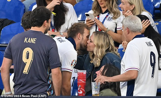 Skipper Kane kisses his wife Katie in the stands after scoring the winner for England on Sunday