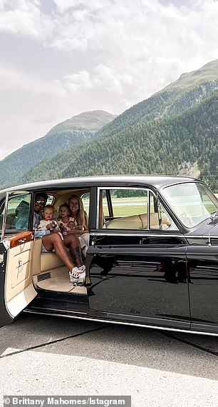 Patrick and Brittany were all smiles for a family pic' in the old school vehicle