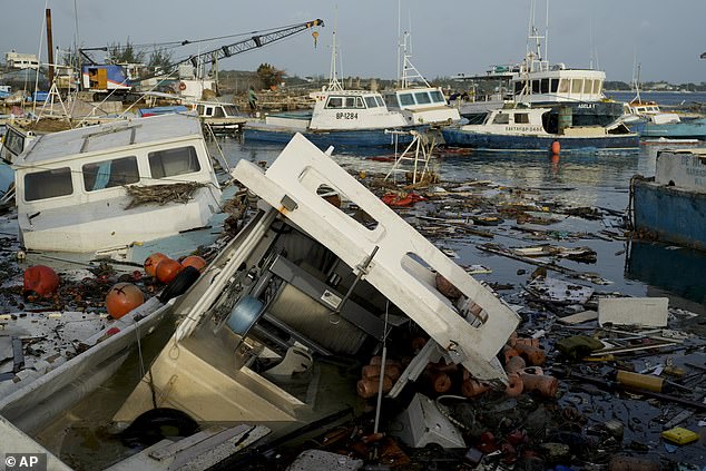 Fishing boats damaged by Hurricane Beryl wade in the water at the Bridgetown Fisheries, Barbados, Tuesday, July 2, 2024