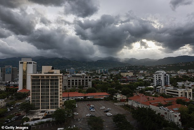 Storm clouds hover over the mountains as people make last-minute preparations for the arrival of Hurricane Beryl on July 03, 2024 in Kingston, Jamaica