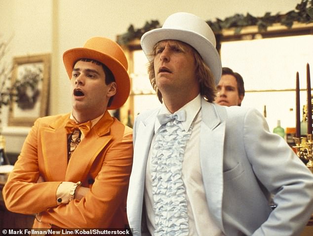 David previously joked during a 2017 appearance on Radio 4's Desert Island Discs: 'I even had a top hat in purple, what was I thinking? I looked like the guys out of Dumb and Dumber' (Jim Carrey (L) and Jeff Daniels (R) pictured in the 1994 comedy)