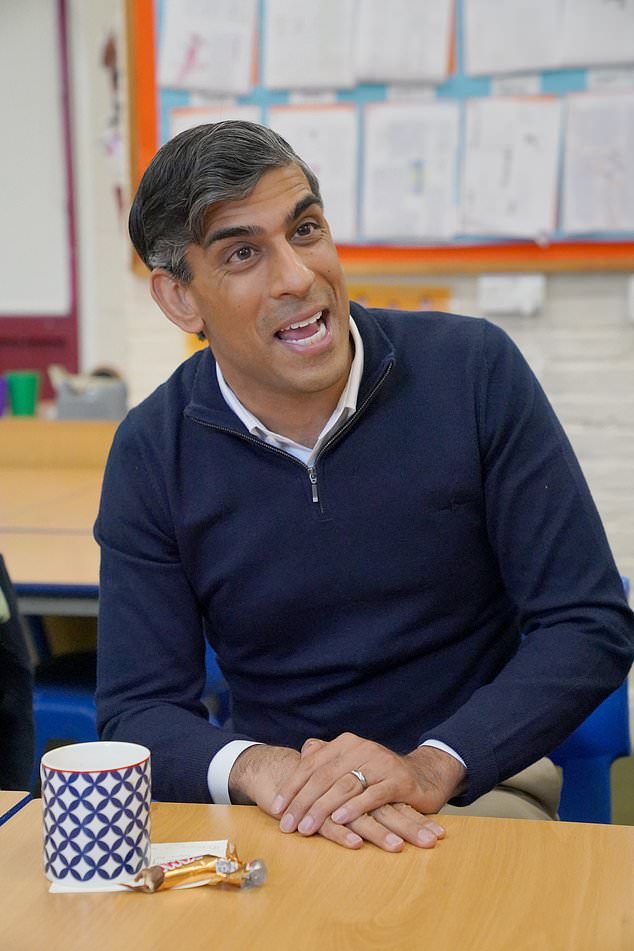 Prime Minister Rishi Sunak speaks to members of the media during a huddle while visiting Braishfield Primary School in Romsey (Jonathan Brady/PA)