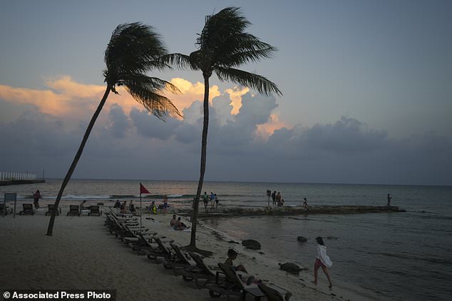MEXICO: People lounge on the beach as the sun sets ahead of Hurricane Beryl's expected arrival, in Playa del Carmen July 3, 2024