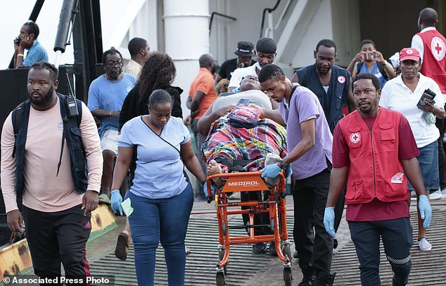 Members of the Red Cross transport a Union Island evacuee on a stretcher as she arrives in Kingstown, St. Vincent and the Grenadines, Wednesday, July 3, 2024. The island, in the Grenadines archipelago, was hit by Hurricane Beryl. (AP Photo/Lucanus Ollivierre)