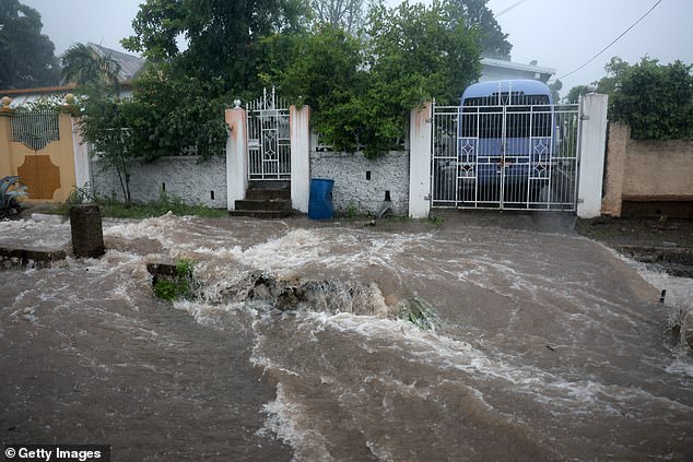 Flood waters pour onto the street as Hurricane Beryl passes through the area on July 03, 2024