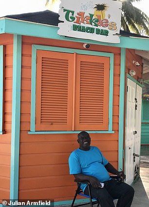 All British expats in Barbados have 'their favourite rum shops or bars', Julian says, such as Tikkles Bar, seen above behind owner Winston