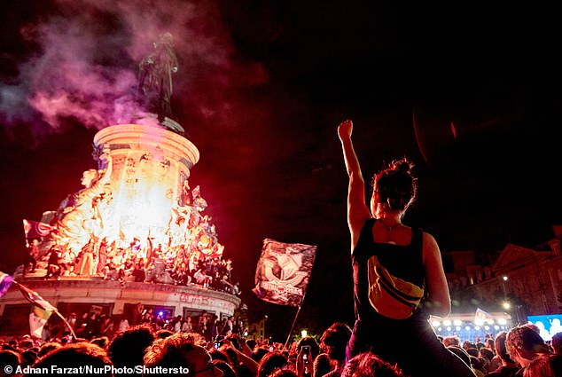 Demonstrators take part in a rally against the RN following the announcement of the results of the first round of the French parliamentary elections at Place de la Republique in Paris on June 30, 2024