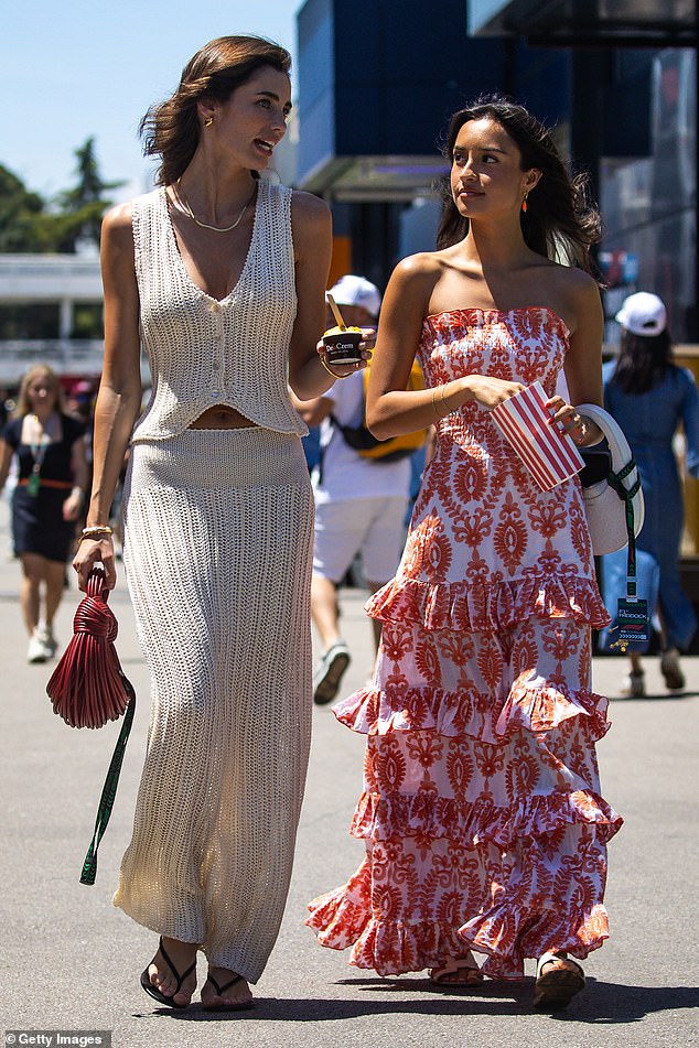Pictured: Alexandra Saint Mleux and Rebecca Donaldson walk in the paddock together ahead of the F1 Grand Prix of Spain last month