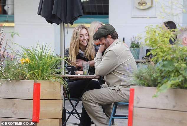 The two appeared deep in discussion as they enjoyed a drink outside