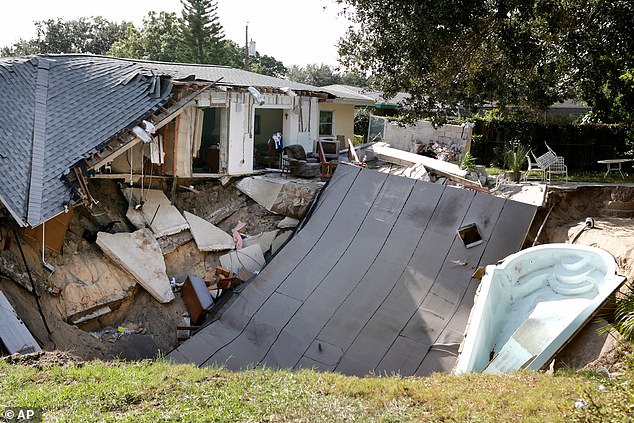 A home is destroyed after the backyard behind the home collapsed into a sinkhole, taking their patio and boat in November 2013 in Dunedin, Florida