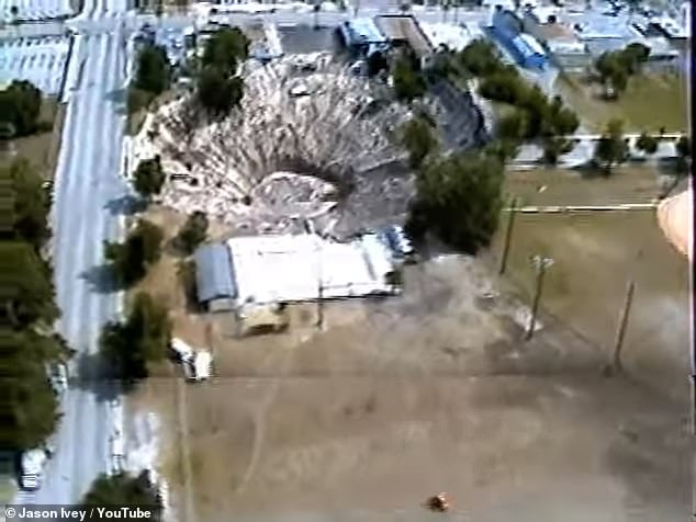 Aerial footage from 1981 shows a major sinkhole in Winter Park, Florida, that caused the collapse of a car dealership, leading to vehicles being submerged to this day