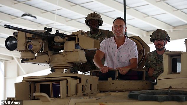 Soldiers from Fort Bliss' 1st Battalion, 37th Armored Regiment, 2nd Armored Brigade Combat Team, 1st Armored Division give Joey Chestnut a close up look at the M1A1 Abrams and M2A3 Bradley Infantry Fighting Vehicle