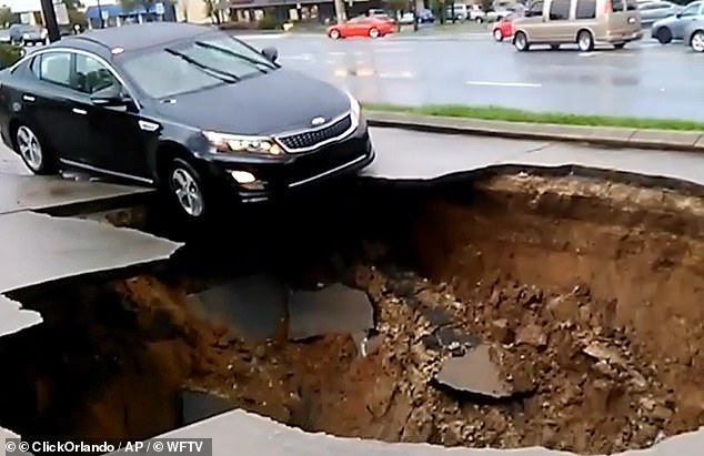 Central Florida has been dubbed 'Sinkhole Alley' after becoming notorious for the dangerous phenomenon where the ground suddenly collapses. Pictured: A car being pulled into a sinkhole in Florida