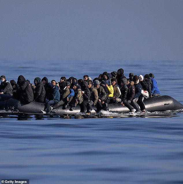 Starmer has promised to officially scrap Rishi Sunak 's flagship Rwanda deportation policy, which he's branded an 'expensive gimmick'. Pictured: Migrants on an inflatable dinghy (File image)