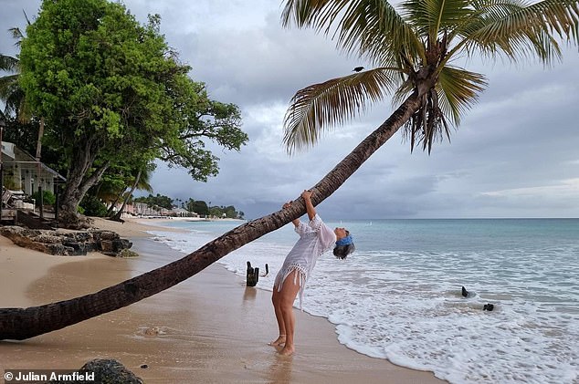 Julian's wife Susan, seen here, has some fun outside the Carib Beach Bar in Christ Church