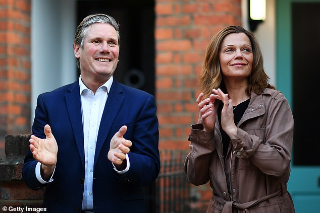 Sir Keir and Lady Victoria clapping for key workers outside their home in London in May 2020. Lady Vic works in the NHS and will not give up her job