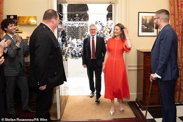 The newly-elected PM and his wife Victoria were clapped in by staff as they entered No10
