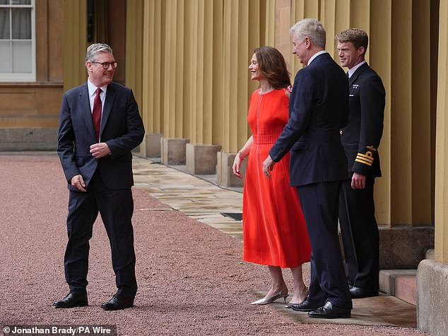 Sir Clive Alderton, Principal Private Secretary to the King and Queen (2nd right) with Commander William Thornton, Royal Navy, Equerry to the King (right) as Sir Keir Starmer, and his wife Victoria Starmer, leave Buckingham Palace in London after an audience with King Charles III