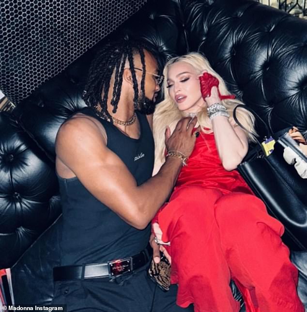 Madonna put on an amorous display with a hunky younger man on July 4 as she reflected on the one-year anniversary of her near-death health scare