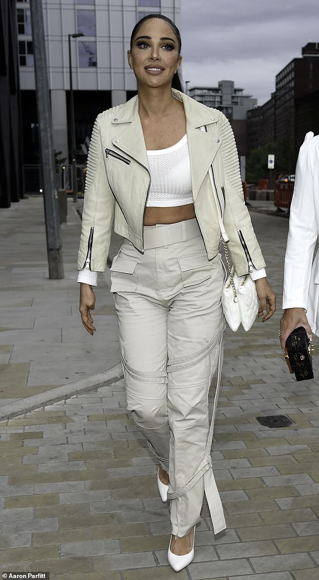The rapper, 35, sported a ribbed white crop top and flashed a glimpse of her taut midriff as she headed to the luxurious bar in celebration of her pal's birthday