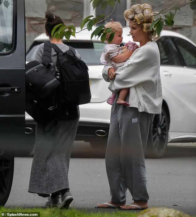 While arriving at the hotel, Molly sported a pair of grey jogging bottoms and rocked hair rollers as she carried her daughter Bambi, 17 months, out of the car