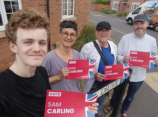 The 22-year-old Cambridge University researcher won his seat in North West Cambridgeshire by just 39 votes. He is seen here with a group of Labour members while canvassing in his local constituency