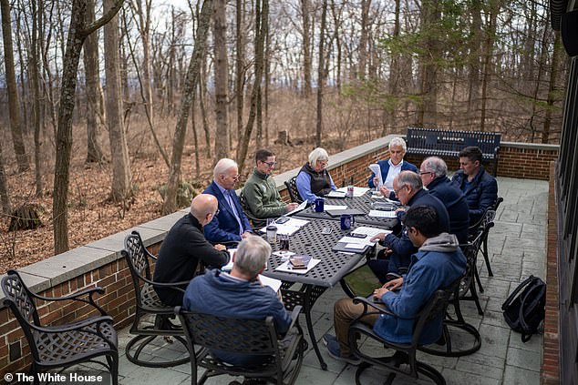 Biden likes to do prep work at Camp David - above he and his team prepare for the State of the Union address at Camp David in March