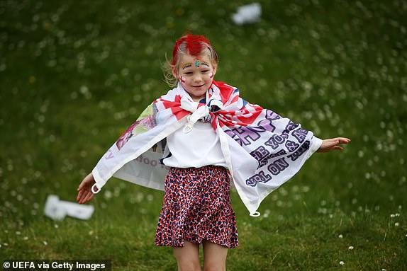 DUSSELDORF, GERMANY - JULY 06: A young fan of England enjoys the pre match atmosphere on the outside of the stadium prior to the UEFA EURO 2024 quarter-final match between England and Switzerland at DÃ¼sseldorf Arena on July 06, 2024 in Dusseldorf, Germany. (Photo by Cathrin Mueller - UEFA/UEFA via Getty Images)