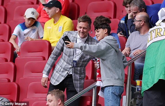 DUSSELDORF, GERMANY - JULY 06: English golfer, Ian Poulter, takes a selfie photograph with a fan in the stands prior to the UEFA EURO 2024 quarter-final match between England and Switzerland at DÃ¼sseldorf Arena on July 06, 2024 in Dusseldorf, Germany. (Photo by Alex Livesey/Getty Images)