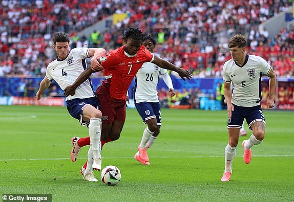 DUSSELDORF, GERMANY - JULY 06: Breel Embolo of Switzerland is challenged by Declan Rice of England during the UEFA EURO 2024 quarter-final match between England and Switzerland at DÃ¼sseldorf Arena on July 06, 2024 in Dusseldorf, Germany. (Photo by Richard Pelham/Getty Images)