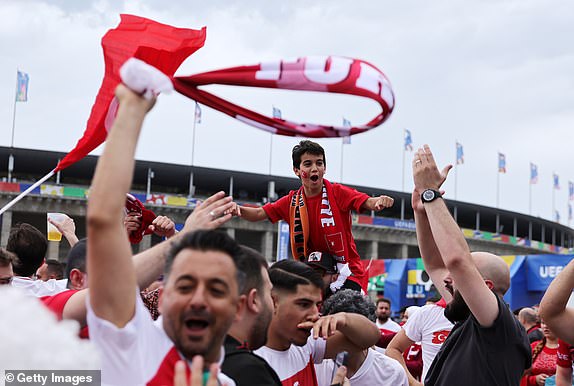 BERLIN, GERMANY - JULY 06: Supporters of TÃ¼rkiye singing and dancing outside the Stadion prior the UEFA EURO 2024 quarter-final match between Netherlands and TÃ¼rkiye at Olympiastadion on July 06, 2024 in Berlin, Germany. (Photo by Christina Pahnke - sampics/Getty Images)