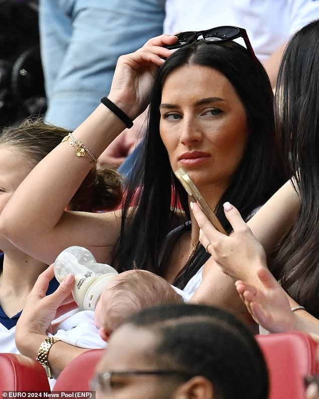 Meanwhile the footballer's wife Annie Kilner joined him at the game in Dusseldorf  (pictured) and watched from the stands as she fed the couple's two-month-old son Rezon